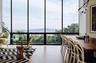A Home with Eclectic Style Looks Just Right - Photo 7 of 19 - The living-dining room overlooks the neighborhood and the Bay beyond. The Safari chair was designed by Jens Quistgaard. Michael Thonet chairs are paired with a walnut table by Anthony Marschak for Original Timber Co.