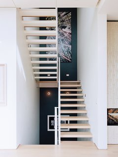 A Home with Eclectic Style Looks Just Right - Photo 8 of 19 - Across from the entrance is the main staircase, which leads to the bedrooms.