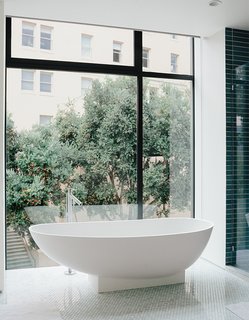 A Home with Eclectic Style Looks Just Right - Photo 12 of 19 - The bathroom features a tub by Benedini Associati for Agape, Dornbracht tub filler, and retractable shades.