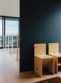 A Home with Eclectic Style Looks Just Right - Photo 14 of 19 - A sliding door separates the upstairs hall from the master bedroom, furnished with a pair of Donald Judd chairs.