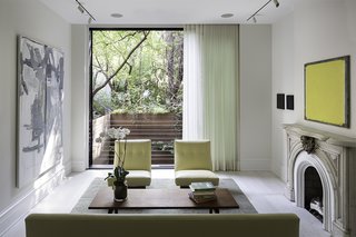 The West Village renovation was the second project Lubrano completed for her client. "She is a collector of contemporary art and has minimalist design sensibilities, so she was not necessarily interested in reiterating typical attitudes of how a historic townhouse should present itself," Lubrano says. "This residence creates a mood that is queued not through a rote familiarity, but through a pleasure in precision and a confidence in form making."<br><br>One of the main challenges was integrating the interiors with the outdoor areas—a luxury in dense Manhattan. On the parlor floor, a floor-to-ceiling window overlooks the patio.