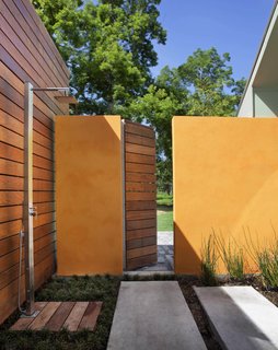 These 13 Outdoor Showers Will Make You Consider One For Your Own Yard - Photo 12 of 13 - The shower offers a multisensory experience: the architect described how clients can take hot showers in the rain or simply lounge in the capacious garden area. Mint plants growing between the pavers release a pleasant smell when stepped upon.