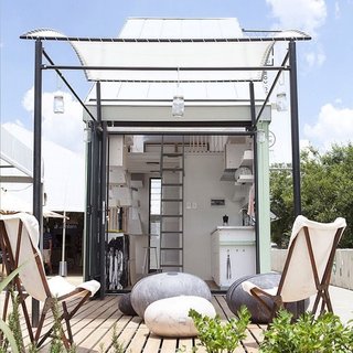 10 Tiny Homes You Can Build - Photo 9 of 10 - A wavy retractable awning structurally defines the outdoor space of this prefab pod concept in South Africa.
