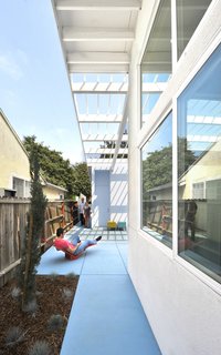 "The sites were extremely constrained; a circumstance we really welcomed," Lehrer says. "While some streets were in better shape than others, the basic urban housing fabric is intact. Our work is precisely to respect the existing fabric, understanding typology and what makes the streets coherent. Just blending in seamlessly would neither honor nor energize the street. It required some invention, palpable freshness and optimism." The 99th Street house is shown here.
