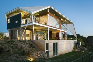 Striking Green House with a View in El Salvador - Photo 1 of 7 - Architect José Roberto Paredes’s crowning achievement is the freestanding concrete roof that wraps around the structure.
