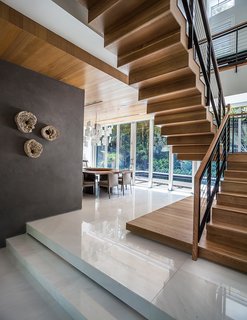 The ground level contains the living and dining spaces. Upstairs there are two bedrooms, plus the master suite.