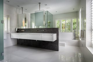 Echoing the facade, dark stone and wood are used throughout the interiors.
