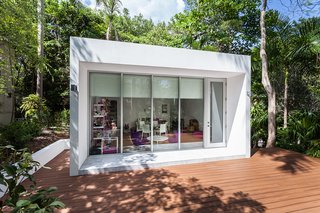 The structure is surrounded by a large deck for play.