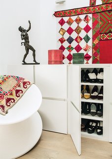 The custom shoe cabinets at the top of the stairs double as a balustrade.