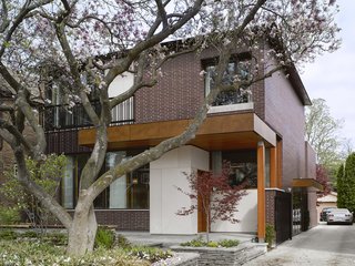 The house responds to its site. "The design was directly influenced by two mature, century-old magnolia trees in the front and a Japanese maple in the rear," Tedesco says. "The location of widows and main program spaces, such as the living room and master bedroom, were strategically placed to take full advantage of views of these trees. Because the trees are fully visible from the interior, seasons and the trees' yearly blooming cycles play a significant role in daily life—they're not just landscape elements. The window sizes and their locations were coordinated with the existing trees to take advantage of passive solar shading in the summer and solar gain in the winter months when the trees do not have foliage."