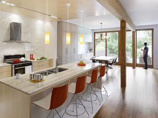 The kitchen is outfitted with a duel-fuel range by Bosch, a Diamonte Canopy hood by Faber, a LaPerla dishwasher by Miele, French-door refrigerator by LG, Blanco sink, and Compact Smart overn by Breville. Catifa 46 stools by Arper are stationed at the bar. The counters are quartz and the cabinets are solid maple. "Given that the owners’ intention was to stay and age in the house, we decided that the materials needed to be elegant and timeless and, in essence, could also age well in place," Tedesco says. "This led to devising a refined and warm palette of natural finishes. White carrara marble, oiled clear Douglas fir, and maple floors and millwork create a light, warm interior with a reddish hue that emanates when the sunlight washes the woods. The selection process included R-and-D on the materials to assess their ability to be both robust enough to handle every day wear and tear in the short term and acquire a beautiful patina long term. We also researched MSDS charts to ensure they were safe, non-toxic, and would not off-gas."