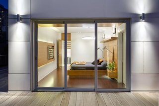 The emphasis on linearity and natural materials continues into the master bedroom, where the flooring is a brown leather plank floor from Torlys. The bedside lights are from Dark Tools.