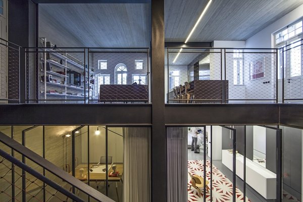 Formerly the home of David Ben-Gurion, the country's first prime minister, the apartment had both historic significance and severe restrictions awaiting the design team of Irene Goldberg, Tamar Berger, and Pitsou Kedem. To add space yet save the facade from the risk of damage, the architects came up with a novel solution: aim lower. A set of temporary beams and pillars allowed them to engineer and excavate a new basemant and create a massive well of open space, framed by the steel beams that define each floor. Photo of Minimal Reboot modern home