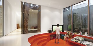 The sunken family room is enlivened by Alvarez-Calderón’s addition of fabrics from Designers Guild and glossy paint.