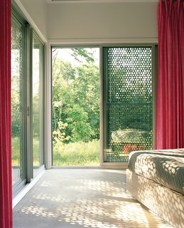 5 Sustainable Ways To Beat the Heat Without Air Conditioning - Photo 3 of 11 - Perforated metal on the exterior of this home filters light coming in, providing shade and a desired aesthetic effect on the interior and exterior.