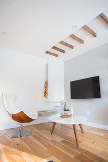 25 Homes With Exposed Beams: Rustic to Modern - Photo 8 of 25 - In lieu of a fireplace, the pair opted for an exposed ethanol burner mounted on exposed concrete (the wood is just decor).