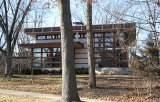The Rudin House in Madison—built following Lloyd Wright's prefabricated Plan #2 for Marshall Erdman's company—is one of two homes built as a large, flat-roofed square with a double-height living room accented with a wall of windows. 