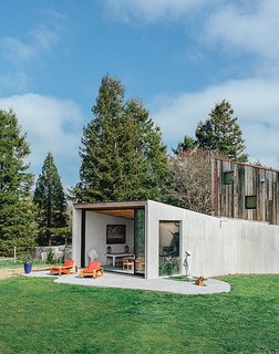This Home is Complete with an Indoor Jungle - Photo 1 of 5 - The Sonoma County home of Lars Richardson and Laila Carlsen is the result of a long-running collaboration with architect Casper Mork-Ulnes. A 713-square-foot indoor-outdoor Shotcrete dining pavilion dubbed the Amoeba provides a loose counterpoint to the more rigid barn structure behind it.