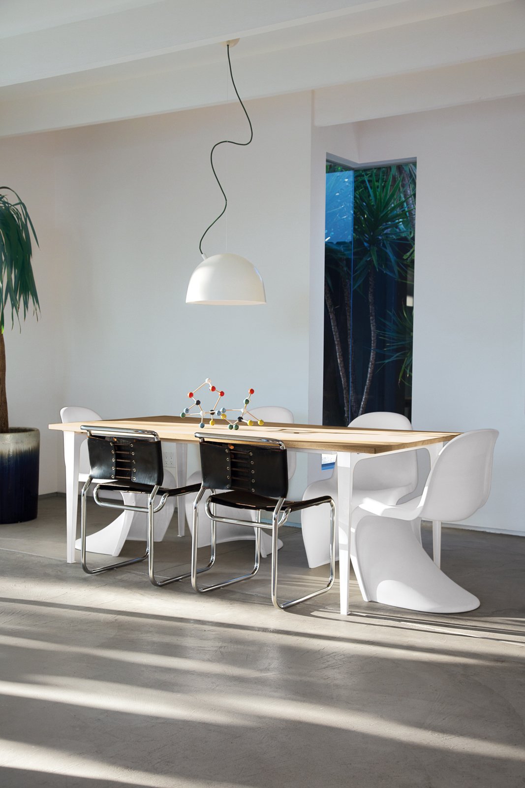 The couple hand-selected every piece of furniture in the house and perused Craigslist to find the four Verner Panton stacking chairs surrounding a Pure dining table from CB2. The two tubular steel side chairs are from Danish Modern L.A., and the pair purchased Muuto’s Plugged Pendant lamp from A+R. Mays and Campbell received the Molecule Building Set as a gift; it’s available from Ferm Living.