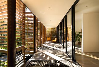 10 Ways to Use Rugs in Your Outdoor Space This Spring - Photo 6 of 10 - The shutter system creates a stunning interplay of light in the front patio space. At night, the shutters glow in the streetlight, "creating the sense of a magical Japanese tea house," according to resident Melissa Brillhart.
