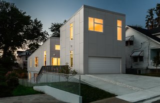 The house, shown here from the street, was designed for two full-time residents and to accommodate visiting children and grandchildren. Its name—the 10 Degree House—comes from the roof's angle.