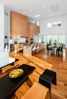 Tall celings help the house feel more spacious. The house is designed for two full-time residents and to accommodate their visiting children and grandchildren. A bedroom is located just past the second floor overlook.