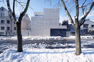 10 Homes With Distinctive Facades - Photo 10 of 10 - Architect Rok Oman of OFIS Architects started the renovation of what would become Villa Criss-Cross by tackling a thorny site issue. Since it is located close to the street and perpendicular to the old Roman wall near Ljubljana's ancient fortress, zoning laws require buildings to be set four meters back from the street. By maintaining the original wall and adding steel panels, Oman grandfathered in the new structure and maintained the original orientation.