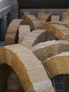 Complementing a British architect is British sculptor Andy Goldsworthy. A site-specific installation, Stone Sea consists of 25 10-foot arches comprised of stone from the Earthworks Quarry in nearby Perryville, Missouri. Coming in at a whopping 13 tons each, the arrangement of the arches mimics waves of the seas that once covered St. Louis and will occupy space bridging the Main Building with the East. Installation in progress. Image courtesy of the Saint Louis Art Museum.