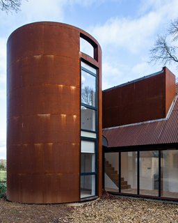 These 10 Refreshed Barns Bring Modern Living to the Countryside - Photo 4 of 10 - A circular tower echoes the former gas storage cylinder that once occupied its place. It houses a private study.