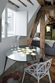 One of Herrman’s designs, the Enlightened Table, appears to reflect a lamp’s light, although nothing hangs overhead.