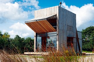 Transformer or beach hut? Positioned in a coastal erosion zone, this holiday retreat for a family of five is completely capable of being relocated. An oversized shutter allows for protection from the elements when not in use and opens to allow sun in during the winter or provide shade on hot summer days. Waikato, New Zealand. By Crosson Clarke Carnachan Architects, from the book Rock the Shack, Copyright Gestalten 2013.