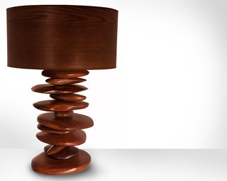 The hand carved walnut "rocks" that form the base of this Rock Pile lamp are stacked and spin independently of one another, allowing the pile to change shape. "In contrast to the pixel style of design I often incorporate into pieces, these rocks are my way of being more freeform and not so meticulous," says Michael Rupich.