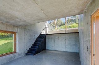 The single skylight helps light the artists' workstation. The simple interior, really a shed with smooth concrete surfaces, provides a stark yet airy space for creative pursuits.