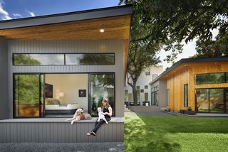 A Mighty Oak Tree Frames This Family Home in Austin - Photo 9 of 10 - The bedroom wing flows smoothly from the interior to the garden. The tongue-and-groove of the bedroom’s ceiling continues out onto the roof’s soffit. A private porch allows the owners to enjoy their backyard with a modicum of privacy.