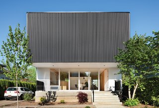 10 Homes With Distinctive Facades - Photo 4 of 10 - Architect Ben Waechter wrapped the upper floor of Nick Oakley’s house in inexpensive black corrugated steel. Waechter opened up the ground floor and added 800 square feet in the form of a second story that cantilevers over both the front and rear elevations. "Ben’s work has a humility about it: a sense of purity and functionality, and a simple architectural gesture that made it stick in my head," said Oakley. 