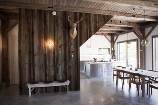 8 Beautiful Home Projects Using Reclaimed Wood - Photo 7 of 8 - As barns become obsolete, they become fruitful sources of salvaged wood, like this house in the Catskills in Bovina, New York. Architect Kimberly Peck designed a home for a Norwegian couple that was looking for the perfect mix of warm, Scandinavian design and midcentury modern. The wood boards on the walls and the posts and beams are all reclaimed, but from different sources. The structural elements were recycled from a barn built in 1840, and the reclaimed planks on the walls were stained with a gray wash to match the other wood. 