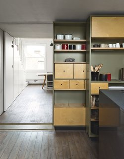 This Is How You Can Live Large in a Small Space - Photo 6 of 9 - A sliding storage wall can be tucked aside to allow a seamless connection to the living and dining area.