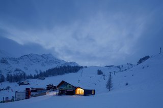 This Prefab Ski School in the Alps Took 10 Days to Assemble - Photo 1 of 7 - The Courmayeur Ski & Snowboard School's home is part of a cluster of buildings located in the ski area of Plan Checrouit, at the foot of Mont Blanc. LEAPfactory’s design for the facility, while crisp and contemporary, echoes the design of its neighbors, particularly their asymmetrical gables.