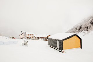 This Prefab Ski School in the Alps Took 10 Days to Assemble - Photo 7 of 7 - The school building sits above the snow, on light piles instead of a permanent concrete foundation. This makes the building easily removable and, according to Girodo, "avoids risks and complications during on-site construction." The environmental impact of the facility’s 10-day dry-assembly was minimal compared to traditional construction methods.