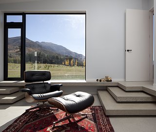 Eames Lounge Chair Porn - Photo 51 of 53 - The clients intend to retire to the house. They asked that rooms be constructed flexibly on a non-domestic scale. This one, with an Eames lounge and floor-to-ceiling glass windows, frames a serene mountain vista like a painting.