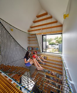This Transformed Melbourne House Resembles a Quirky Village - Photo 3 of 11 - Spinning off the living room on the north side of the main house, the children’s study sits separately from the other pavilions. On its upper level, Oxley netting forms a web on which the kids and their friends can sit and read with views of the leafy street and garden.