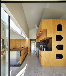 This Transformed Melbourne House Resembles a Quirky Village - Photo 8 of 11 - The house’s dominant gable form repeats at a smaller scale throughout the dwelling, as in the kitchen’s plywood and steel cabinets. "The gable became thematic throughout the process," Maynard explains. "Whenever issues arose, we referred back to it as a default, rather than adding a new idea." The sink is by Abey, faucet by Franke, and range by Qasair.