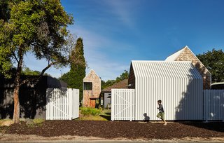 These 11 Modern Fences Bring a Whole New Meaning to Curb Appeal - Photo 7 of 11 - A small country road borders the property to the west.