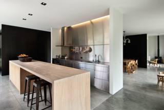 This Kid-Friendly Home is Full of Surprises - Photo 5 of 9 - In the kitchen and dining room, Cooke rethought traditional wood panelling using black pigment-stained veneer.<br><br>The kitchen has expansive surfaces, including a long, wood-topped kitchen island where the couple cook and entertain, and where the children eat and play. "All of the materials were selected for their integrity and longevity," says Bergendy.