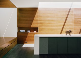 The residence architect Cary Bernstein designed for Scott Croyle and his family is an exercise in hide-and-seek. Clever storage keeps the space clutter-free and lets the structure shine. In the entryway, drawers tuck under the mezzanine, niches hold artwork, and speakers are built in line with the cabinets.