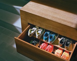 Generous storage is key to an uncluttered look. Drawers for shoes tuck away under the raised mezzanine floor.