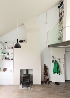 Look for blank space where the added level will blend in with what already exists.<br><br>An industrial white backdrop inspires our work, and natural light pours in through skylights. Searching for an additional place to perch, we noticed a flat area above and behind our conference room—right under two large skylights. As we began to entertain the loft idea, we realized that the conference room ceiling and new loft floor would need to be reinforced. Joists and plywood were the most cost efficient method. When painted white, they fit in with our existing scheme.