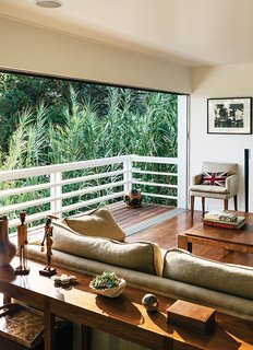A Midcentury Home Enjoys Views from Every Angle - Photo 11 of 14 - The team matched and continued the 1960s-era red oak floor into the living room, which gained an entire wall of new sliders from Western Window Systems. "We wanted to preserve the original intent of the house wherever we could," Dimster notes.