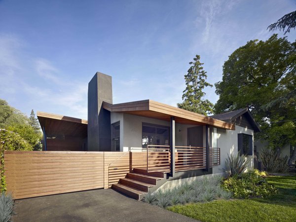 Modern home with outdoor, front yard, shrubs, grass, and horizontal fence. “The most challenging part of the design was fusing the old part of the house with the new addition,” says principal architect Alex Terry. The character and architectural integrity of the single-level 1950s ranch house was thoughtfully reconsidered during the addition and remodel. The home’s front porch, typical of period, was refreshed with ipe decking and railing. Photo 7 of 1950s Ranch