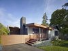 Modern home with Outdoor, Front Yard, Shrubs, Grass, and Horizontal Fence. “The most challenging part of the design was fusing the old part of the house with the new addition,” says principal architect Alex Terry. The character and architectural integrity of the single-level 1950s ranch house was thoughtfully reconsidered during the addition and remodel. The home’s front porch, typical of period, was refreshed with ipe decking and railing. Photo 7 of 1950s Ranch